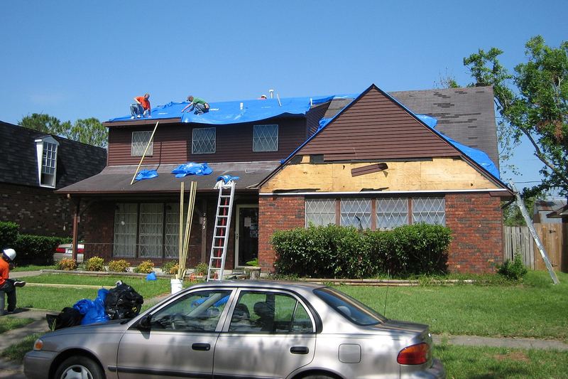Houses with blue tarps after a hurricane