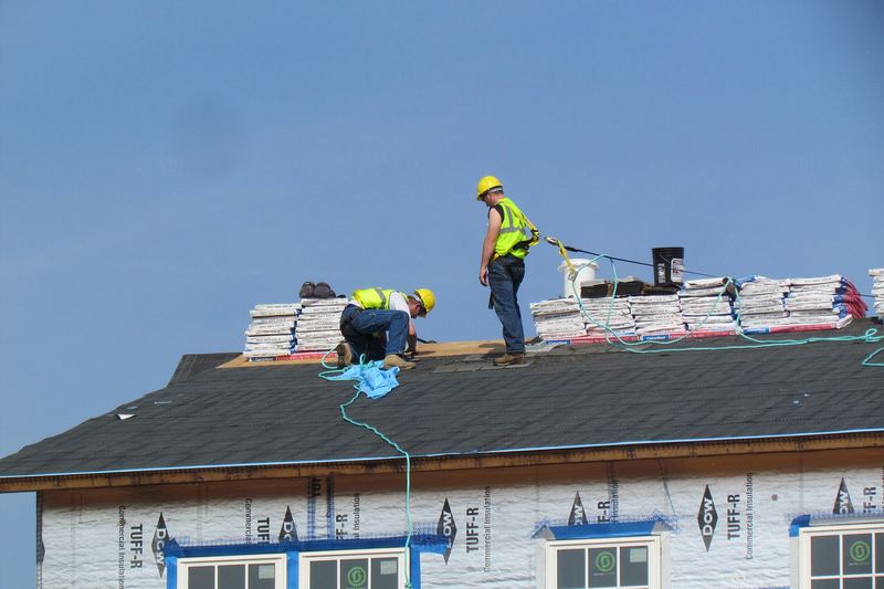 Roofers working on a new house roof
