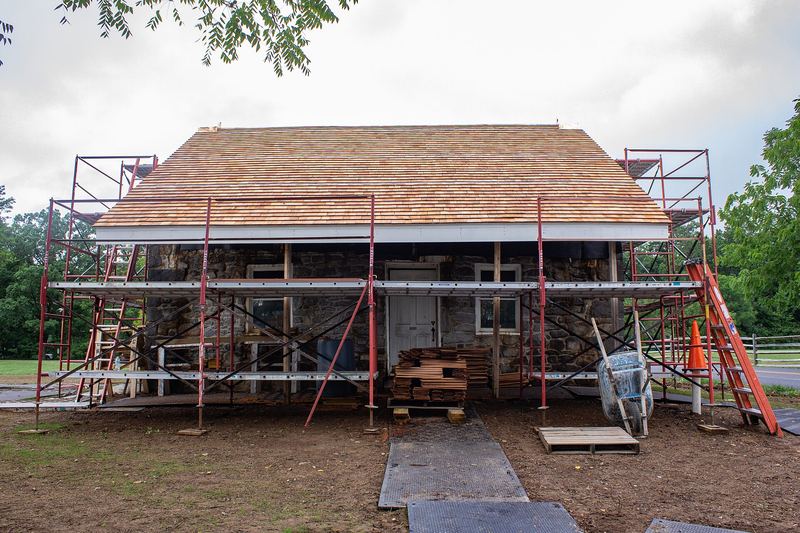 Shingle installation on a house with scaffolding